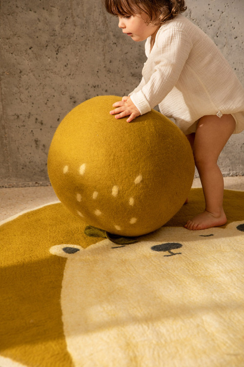 Happy atmosphere in a child's room with the felted apple pouffe