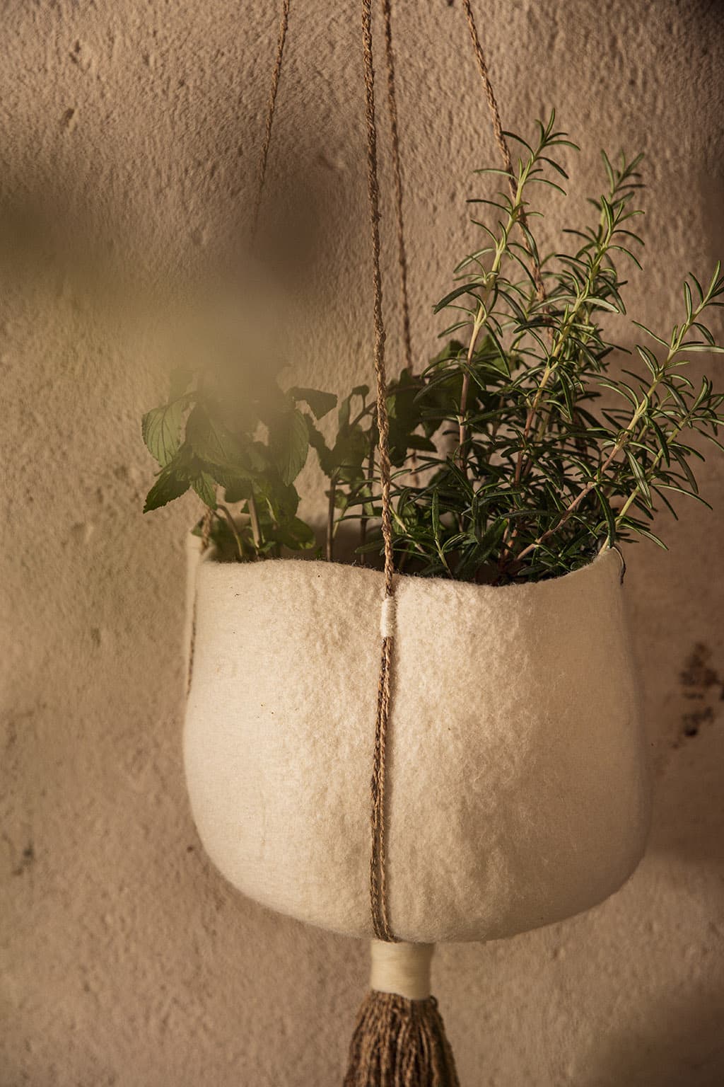 White felt and hemp hanging basket for a plant