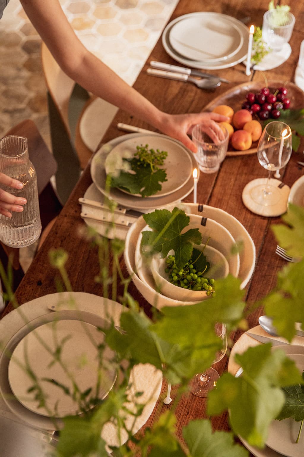 A summer table decorated with baskets and white felted wool placemats